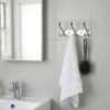 3-Hook Patterned Rail is an elegant, wall-mounted multi-hook utility rack designed to organize robes, towels, and clothing. Featuring a decorative, stylized aesthetic and a mirror-like finish, this multi-tiered storage hanger maximizes space on a single, unified backing track.