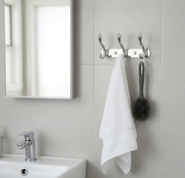 3-Hook Patterned Rail is an elegant, wall-mounted multi-hook utility rack designed to organize robes, towels, and clothing. Featuring a decorative, stylized aesthetic and a mirror-like finish, this multi-tiered storage hanger maximizes space on a single, unified backing track.