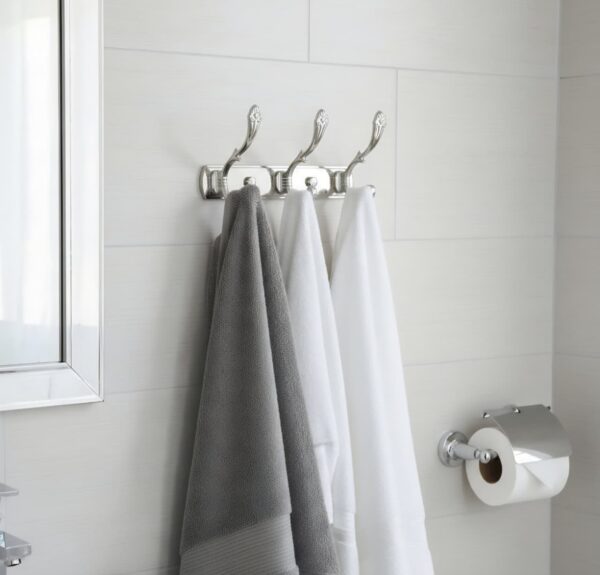 3-Hook Patterned Rail is an elegant, wall-mounted multi-hook utility rack designed to organize robes, towels, and clothing. Featuring a decorative, stylized aesthetic and a mirror-like finish, this multi-tiered storage hanger maximizes space on a single, unified backing track.