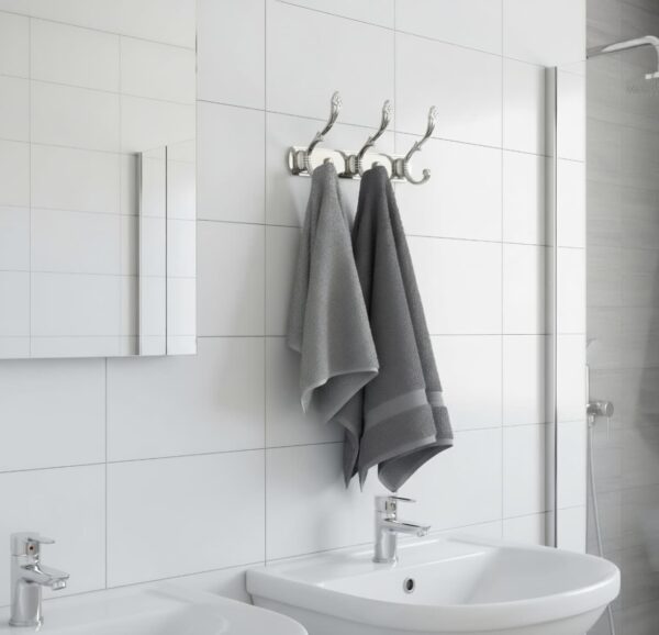 3-Hook Patterned Rail is an elegant, wall-mounted multi-hook utility rack designed to organize robes, towels, and clothing. Featuring a decorative, stylized aesthetic and a mirror-like finish, this multi-tiered storage hanger maximizes space on a single, unified backing track.
